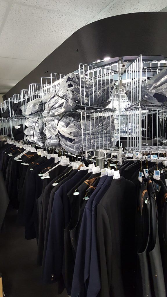 Hangers With Clothes On Garment Conveyor At Dry-cleaner's Stock Photo,  Picture and Royalty Free Image. Image 198000170.